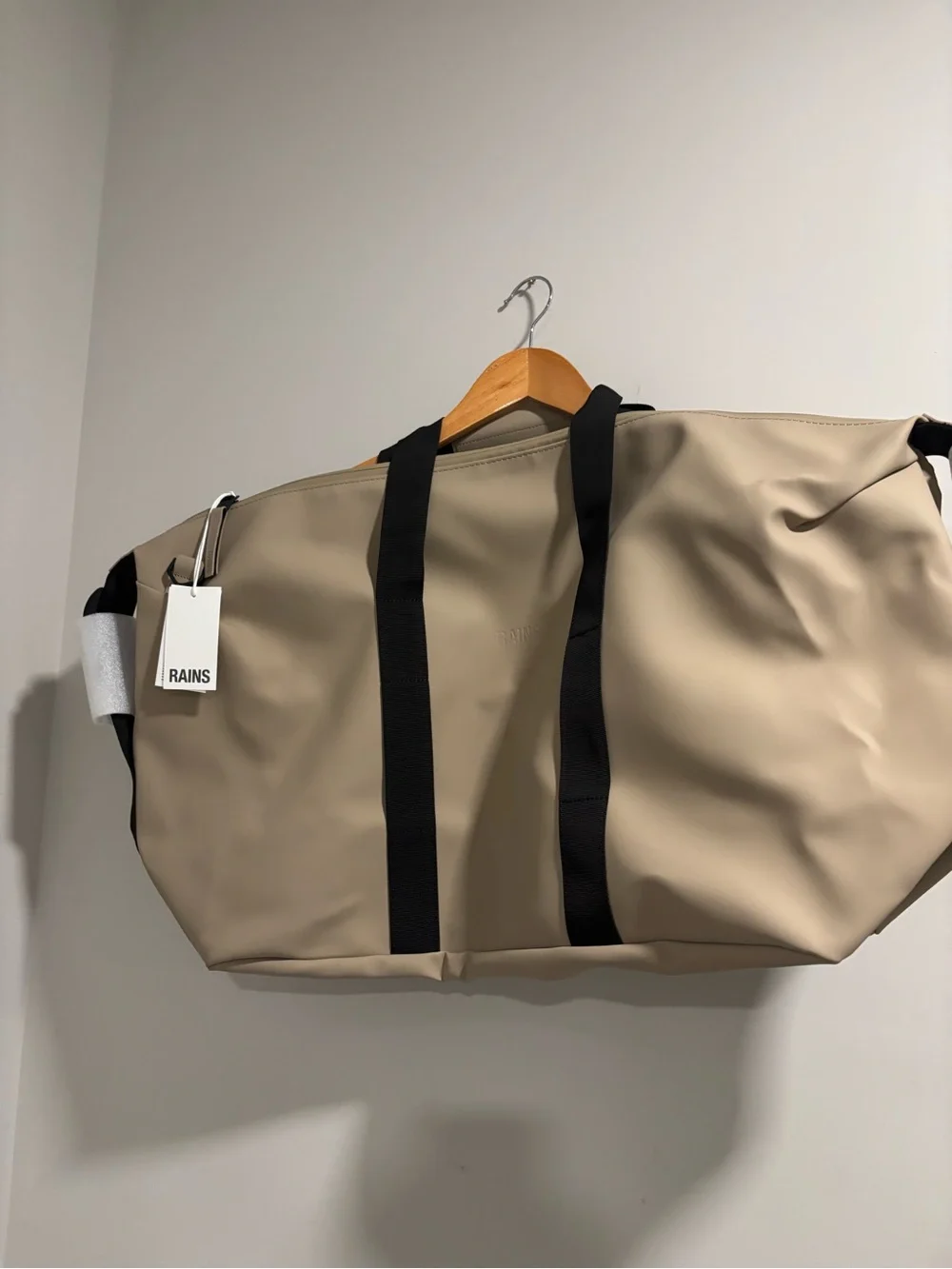 Rains Hilo Duffel Bag in Taupe with Black Straps
